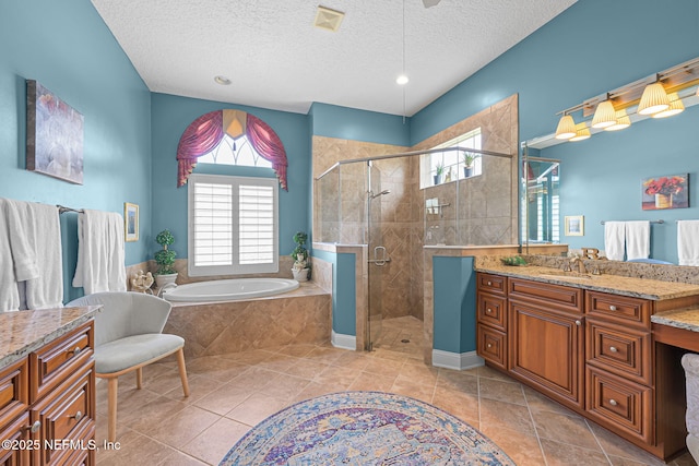 bathroom with a textured ceiling, visible vents, vanity, a shower stall, and a bath