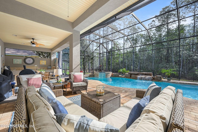 exterior space featuring glass enclosure, a patio, an outdoor hangout area, a pool with connected hot tub, and a ceiling fan