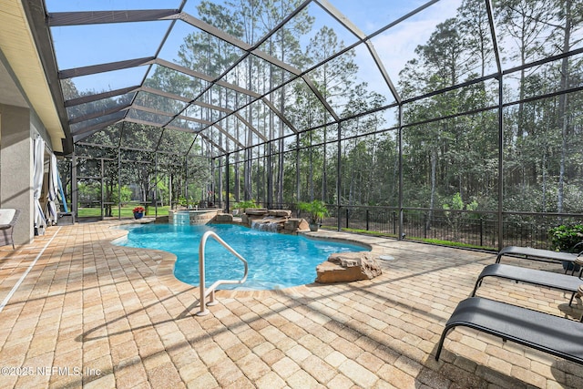 outdoor pool with glass enclosure and a patio