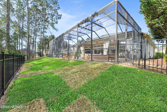 view of yard featuring glass enclosure and fence