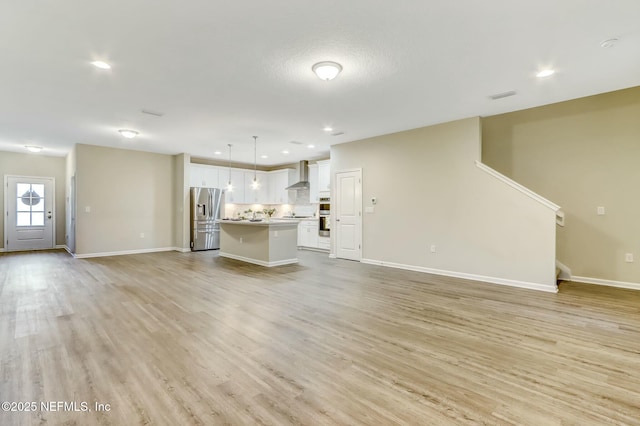 454 Pine Bluff Dr, Saint Augustine, FL 32092 - unfurnished living room with light wood-type flooring, baseboards, visible vents, and recessed lighting
