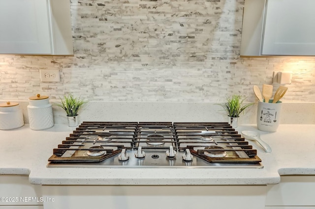 454 Pine Bluff Dr, Saint Augustine, FL 32092 - interior details featuring light stone countertops, tasteful backsplash, stainless steel gas cooktop, and white cabinets