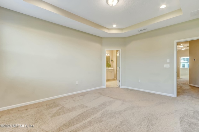 454 Pine Bluff Dr, Saint Augustine, FL 32092 - empty room with a tray ceiling, recessed lighting, light colored carpet, visible vents, and baseboards