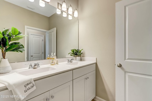454 Pine Bluff Dr, Saint Augustine, FL 32092 - bathroom featuring double vanity, a sink, visible vents, and baseboards