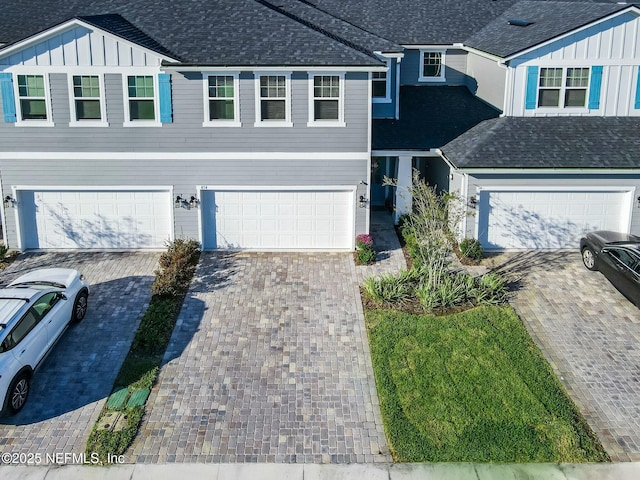 454 Pine Bluff Dr, Saint Augustine, FL 32092 - view of front facade with a shingled roof, driveway, board and batten siding, and an attached garage