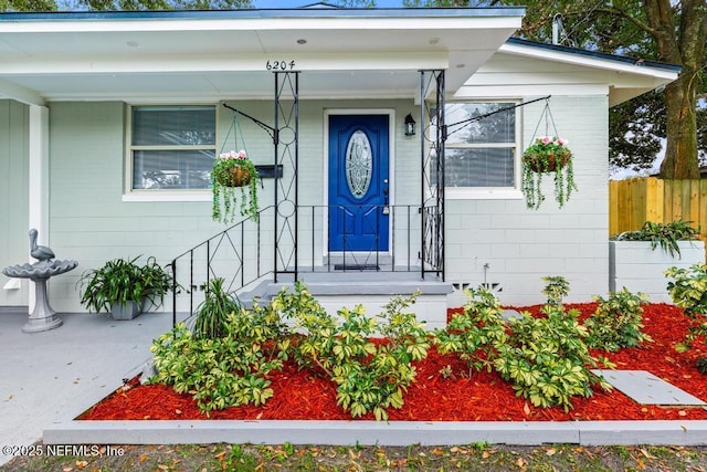 view of exterior entry with concrete block siding