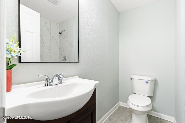 full bathroom with vanity, toilet, and baseboards