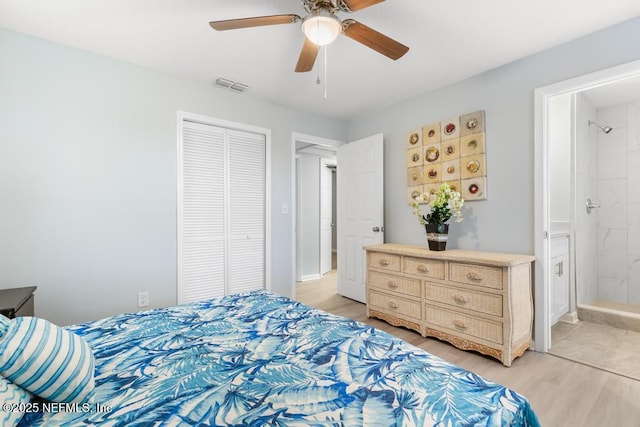 bedroom featuring light wood finished floors, a closet, visible vents, ceiling fan, and ensuite bath