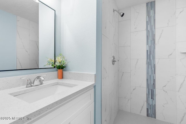 full bath with a shower stall and vanity