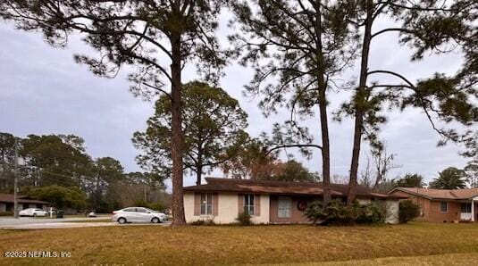 ranch-style house with a front lawn