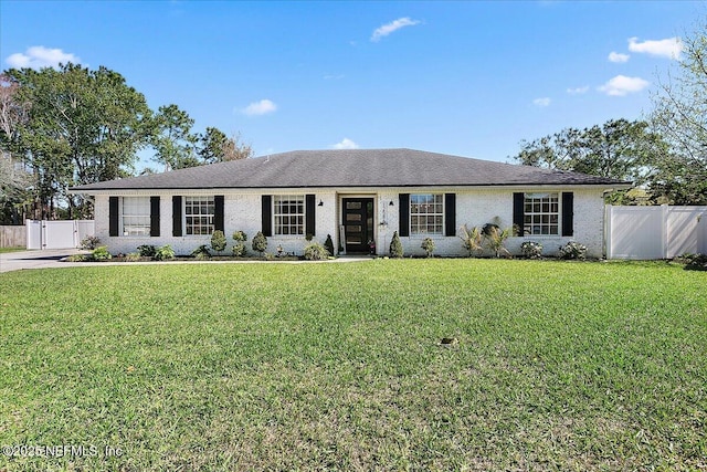 single story home featuring fence, a front yard, and a gate