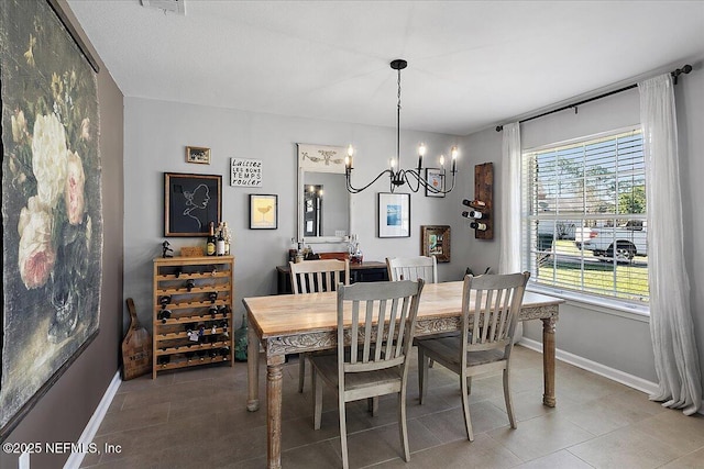 dining room with baseboards and a notable chandelier