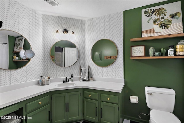 full bathroom featuring visible vents, toilet, and vanity