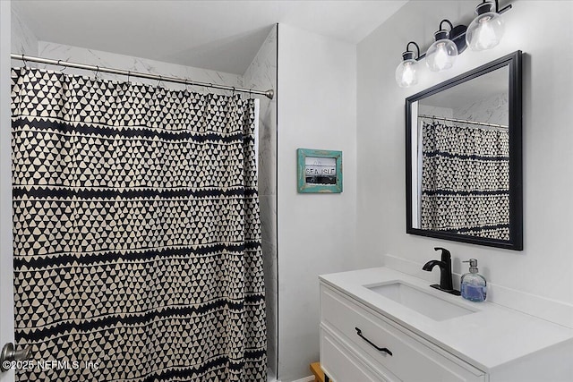 bathroom featuring vanity and a shower with shower curtain