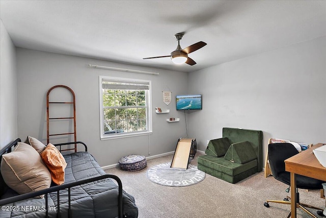 sitting room featuring a ceiling fan, baseboards, and carpet floors