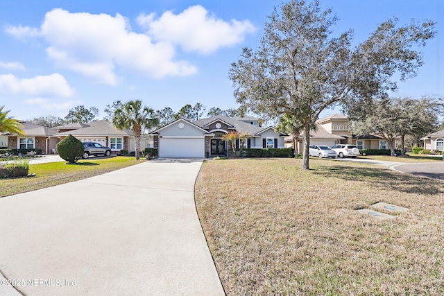 view of front of property featuring a garage, concrete driveway, a front yard, and a residential view