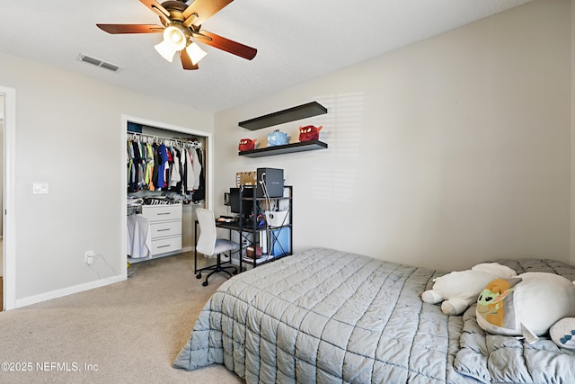 bedroom with visible vents, ceiling fan, carpet, a textured ceiling, and a closet