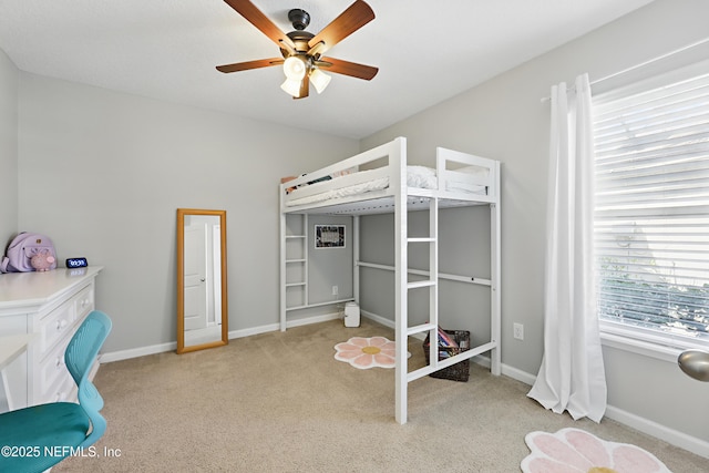 bedroom featuring baseboards, ceiling fan, and light colored carpet