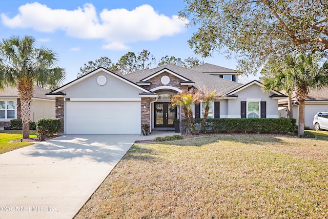 view of front facade featuring a garage, driveway, french doors, and a front yard