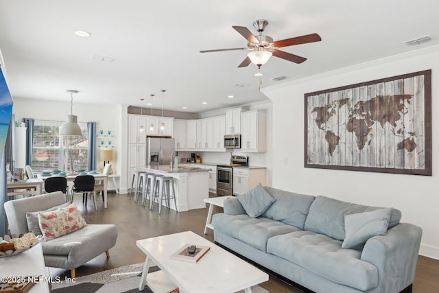 342 4th St N, Jacksonville Beach, FL 32250 - living room with crown molding, visible vents, ceiling fan, and dark wood-type flooring