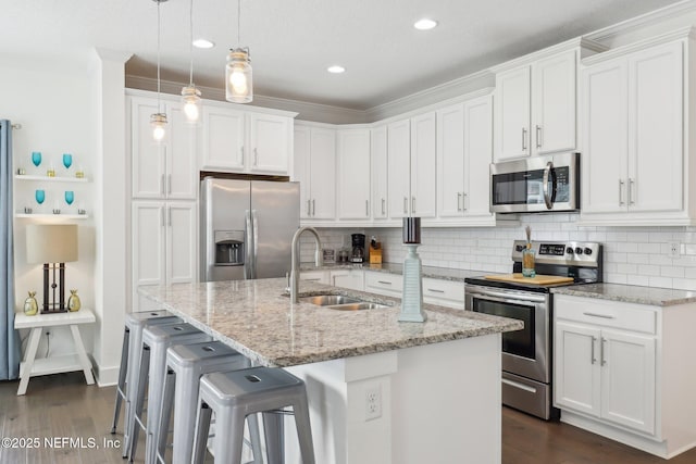342 4th St N, Jacksonville Beach, FL 32250 - kitchen with a sink, white cabinetry, stainless steel appliances, and decorative backsplash