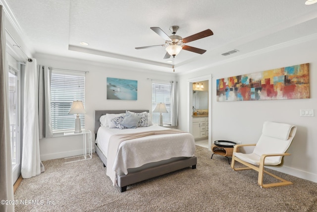 342 4th St N, Jacksonville Beach, FL 32250 - carpeted bedroom with a raised ceiling, visible vents, ensuite bath, and baseboards