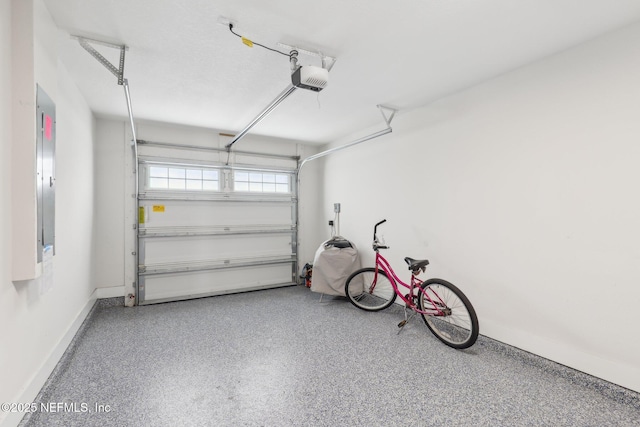 342 4th St N, Jacksonville Beach, FL 32250 - garage with a garage door opener, electric panel, and baseboards