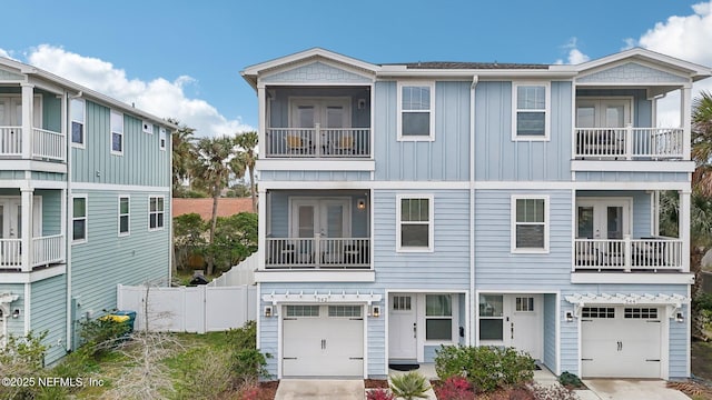 342 4th St N, Jacksonville Beach, FL 32250 - view of property with a garage, french doors, fence, and concrete driveway