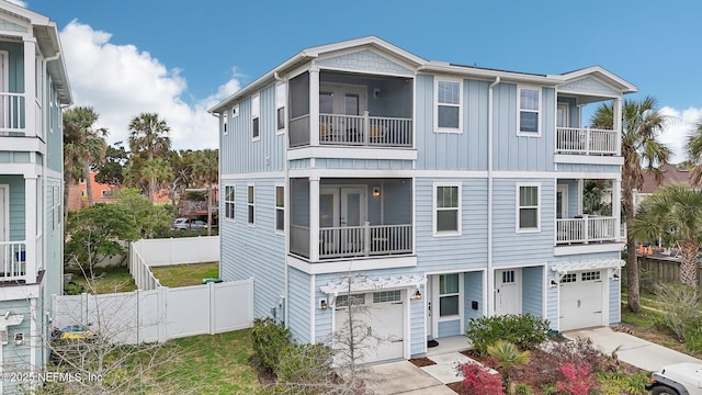 342 4th St N, Jacksonville Beach, FL 32250 - view of front of house with concrete driveway, fence, and an attached garage