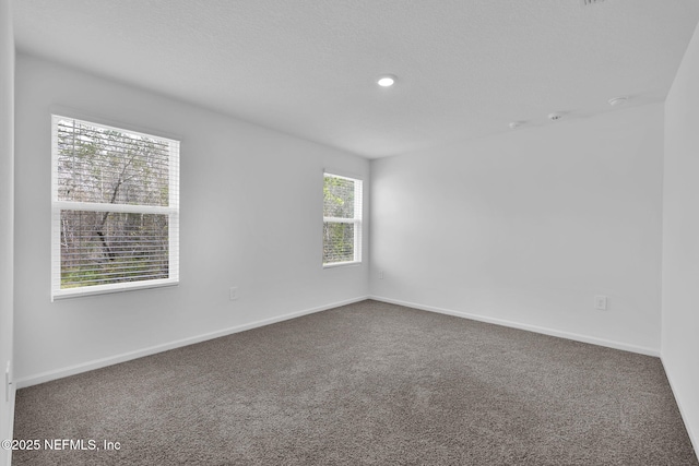 empty room with carpet floors and baseboards