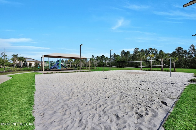 view of home's community featuring a lawn and volleyball court