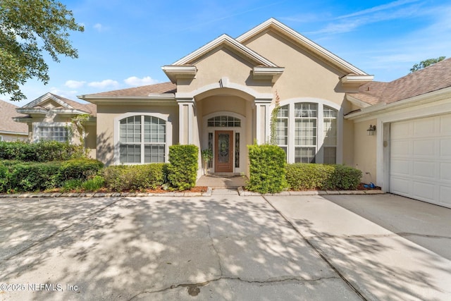 view of front of house featuring an attached garage and stucco siding