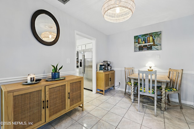 dining area with light tile patterned flooring and baseboards