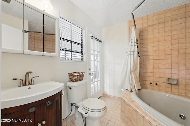 bathroom featuring toilet, tile patterned floors, tiled shower / bath, a textured ceiling, and vanity