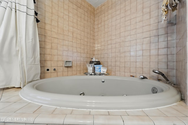 full bath with tile walls and a whirlpool tub