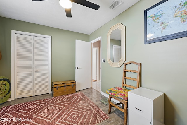 rec room featuring visible vents, ceiling fan, and wood finished floors