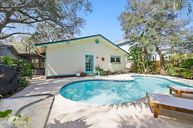 pool with a patio and fence