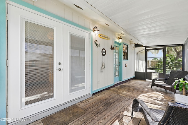 sunroom / solarium featuring french doors