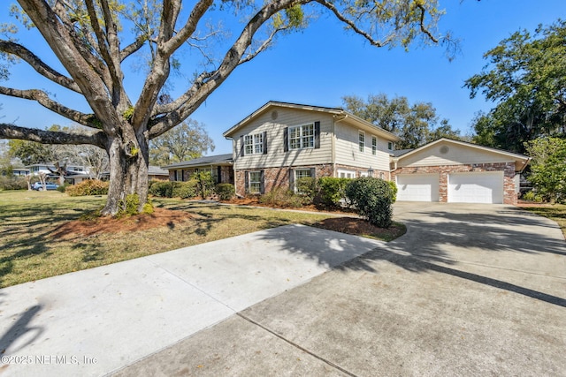 view of front of property featuring a garage, concrete driveway, and brick siding