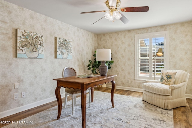 home office with wood finished floors, a ceiling fan, and baseboards