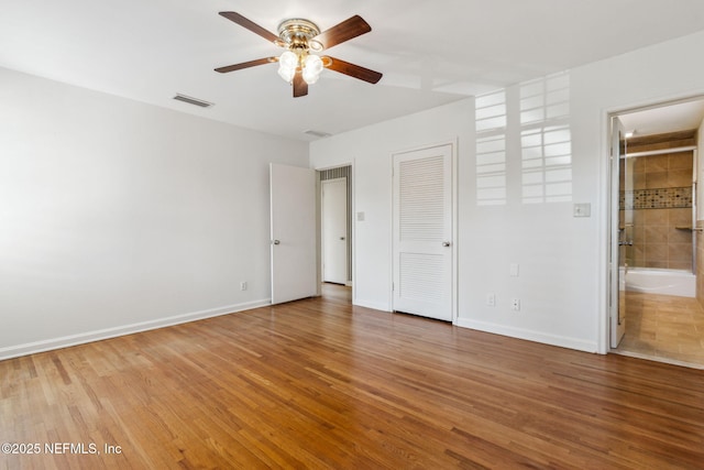 unfurnished bedroom with light wood-style floors, visible vents, and baseboards