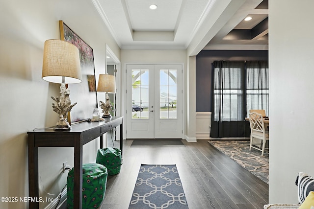 entrance foyer featuring wood finished floors, a tray ceiling, crown molding, french doors, and recessed lighting