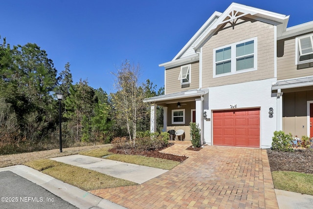 view of front of house with a garage and decorative driveway