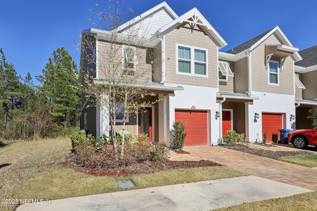 view of front facade with decorative driveway and an attached garage