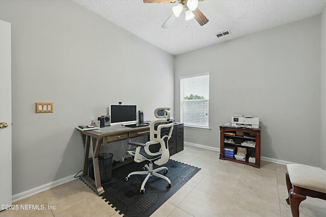 office with a textured ceiling, light tile patterned floors, a ceiling fan, and baseboards