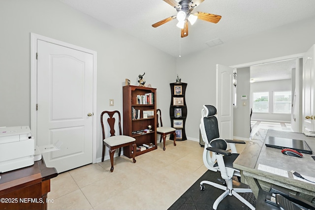 office featuring light tile patterned floors, a textured ceiling, baseboards, and a ceiling fan