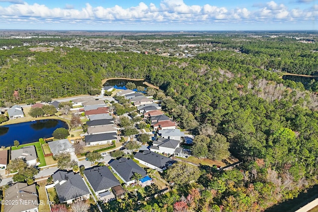 bird's eye view with a residential view, a water view, and a wooded view