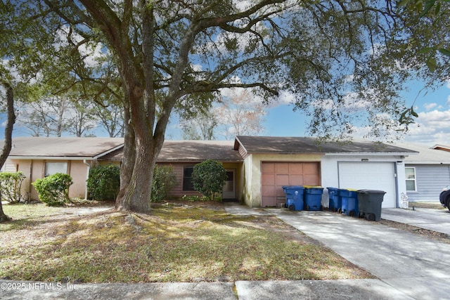 single story home with a garage and driveway