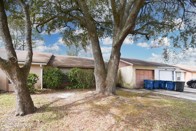 ranch-style house with a garage and concrete driveway