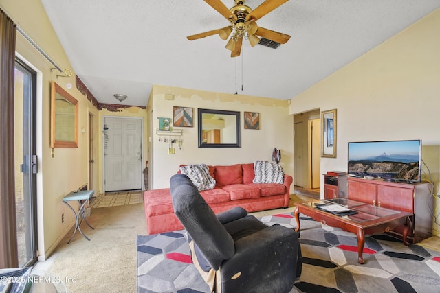 living area with light carpet, a textured ceiling, lofted ceiling, and a ceiling fan